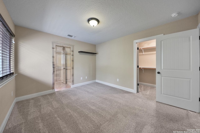 523 White Cyn, San Antonio, TX 78260 - unfurnished bedroom with a spacious closet, carpet flooring, a textured ceiling, a closet, and baseboards