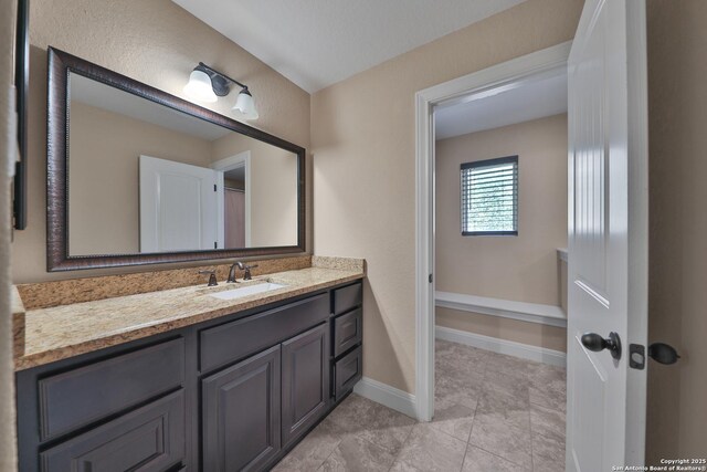 523 White Cyn, San Antonio, TX 78260 - bathroom with vanity, baseboards, and tile patterned flooring