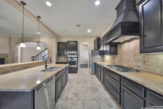 523 White Cyn, San Antonio, TX 78260 - kitchen with stainless steel appliances, a sink, custom exhaust hood, arched walkways, and decorative backsplash