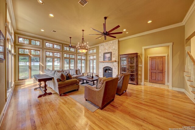 1104 Lois St, Kerrville, TX 78028 - living area with ornamental molding, light wood-type flooring, recessed lighting, healthy amount of natural light, and a stone fireplace