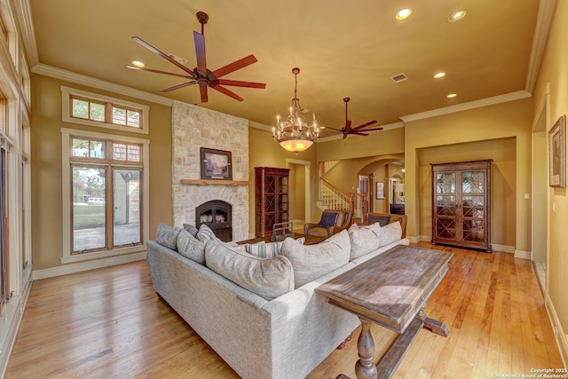 1104 Lois St, Kerrville, TX 78028 - living room with ceiling fan, ornamental molding, a fireplace, stairway, and recessed lighting