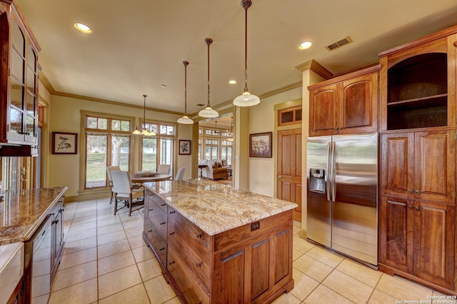 1104 Lois St, Kerrville, TX 78028 - kitchen featuring stainless steel fridge, ornamental molding, a kitchen island, light stone counters, and hanging light fixtures