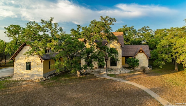 1104 Lois St, Kerrville, TX 78028 - view of front facade with stone siding, stucco siding, and a tiled roof