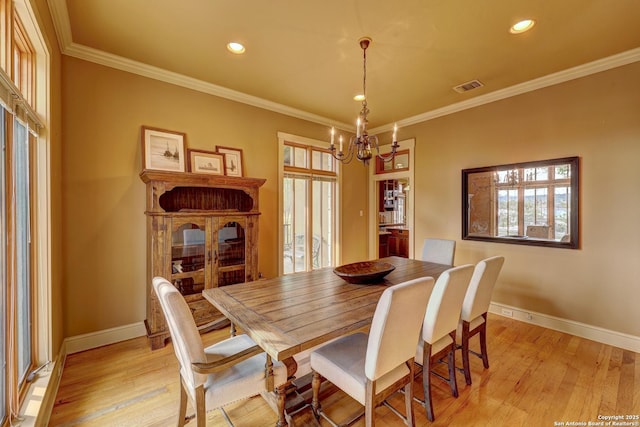 1104 Lois St, Kerrville, TX 78028 - dining space with a chandelier, light wood-type flooring, baseboards, crown molding, and recessed lighting