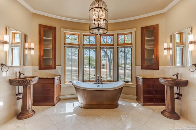 1104 Lois St, Kerrville, TX 78028 - full bath featuring healthy amount of natural light, a freestanding tub, crown molding, two sinks, and a chandelier