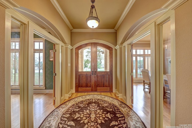 1104 Lois St, Kerrville, TX 78028 - entryway featuring plenty of natural light, french doors, light wood finished floors, and ornamental molding
