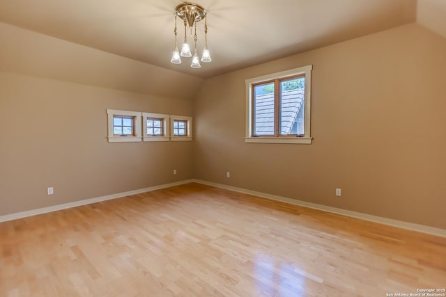 1104 Lois St, Kerrville, TX 78028 - empty room featuring lofted ceiling, light wood-style flooring, and healthy amount of natural light