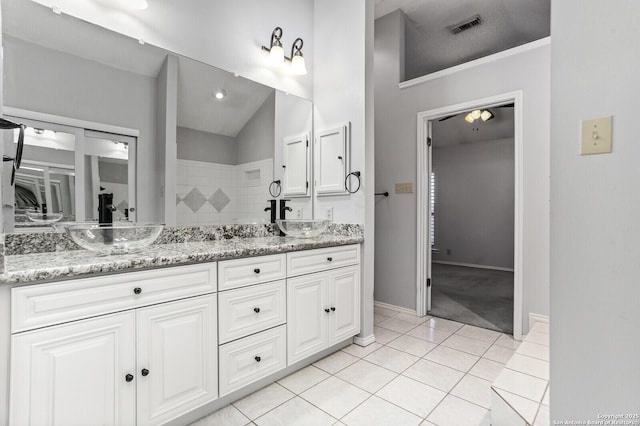 bathroom with tile patterned flooring, double vanity, and baseboards