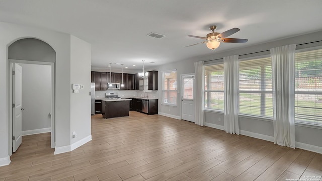 13154 Beals, San Antonio, TX 78253 - kitchen featuring appliances with stainless steel finishes, baseboards, dark brown cabinetry, ceiling fan, and light wood-style flooring
