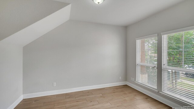 13154 Beals, San Antonio, TX 78253 - additional living space featuring light wood-style floors, baseboards, and vaulted ceiling