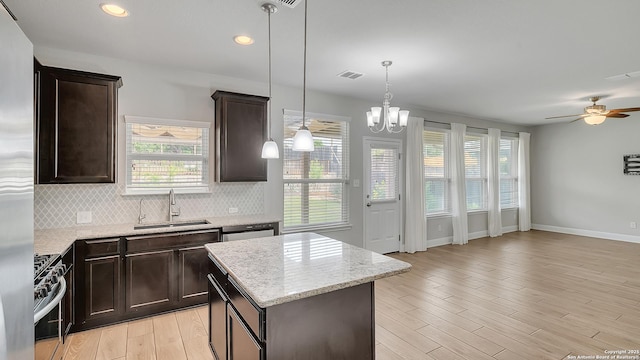 13154 Beals, San Antonio, TX 78253 - kitchen with a sink, stainless steel appliances, backsplash, dark brown cabinetry, and light wood-type flooring