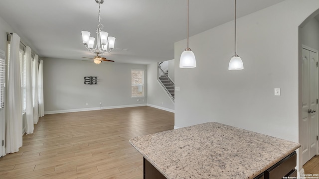 13154 Beals, San Antonio, TX 78253 - kitchen with ceiling fan, arched walkways, light wood-type flooring, baseboards, and a chandelier