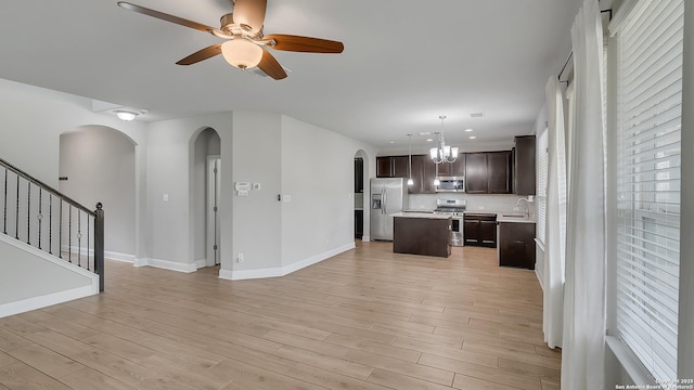 13154 Beals, San Antonio, TX 78253 - unfurnished living room featuring arched walkways, a sink, light wood-style floors, and a chandelier