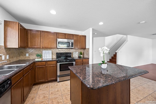 102 Ville Serene, San Antonio, TX 78253 - kitchen with appliances with stainless steel finishes, a sink, tasteful backsplash, a center island, and light tile patterned flooring
