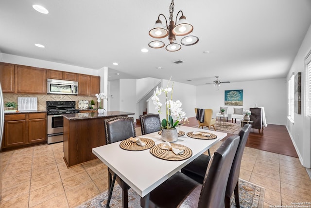 102 Ville Serene, San Antonio, TX 78253 - dining space with light tile patterned floors, ceiling fan, a chandelier, recessed lighting, and stairs