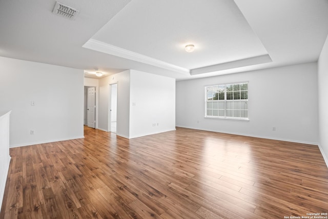 102 Ville Serene, San Antonio, TX 78253 - unfurnished room with a tray ceiling, wood finished floors, and baseboards