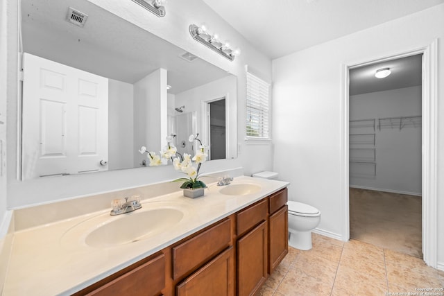 102 Ville Serene, San Antonio, TX 78253 - bathroom with tile patterned floors, double vanity, toilet, and a walk in closet