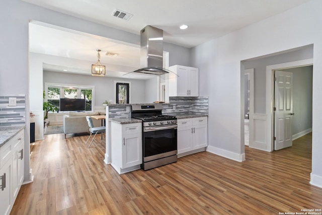 944 Fulton, San Antonio, TX 78201 - kitchen featuring stainless steel gas stove, island range hood, white cabinetry, open floor plan, and tasteful backsplash