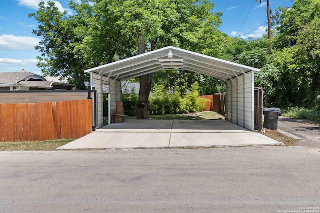 944 Fulton, San Antonio, TX 78201 - view of parking featuring a detached carport, fence, and concrete driveway
