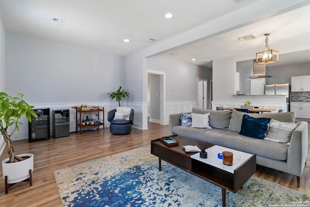 944 Fulton, San Antonio, TX 78201 - living room featuring light wood finished floors, recessed lighting, and wainscoting