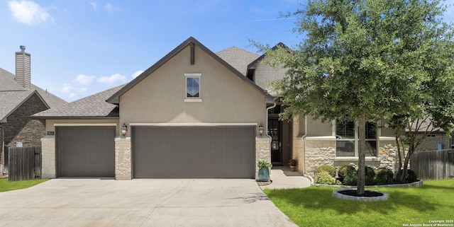 28114 Versant, Boerne, TX 78015 - view of front facade with stone siding, driveway, stucco siding, a garage, and roof with shingles