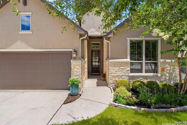 28114 Versant, Boerne, TX 78015 - view of front of house featuring stone siding, driveway, stucco siding, and a garage