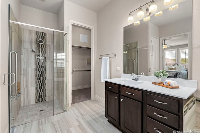28114 Versant, Boerne, TX 78015 - ensuite bathroom with vanity, a stall shower, ceiling fan, and a walk in closet