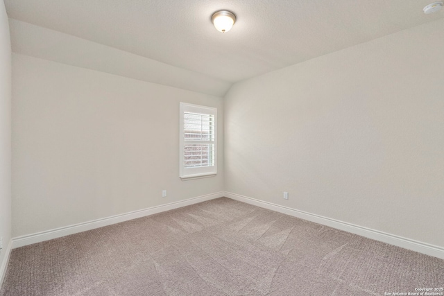 28114 Versant, Boerne, TX 78015 - spare room featuring carpet floors, a smoke detector, and lofted ceiling