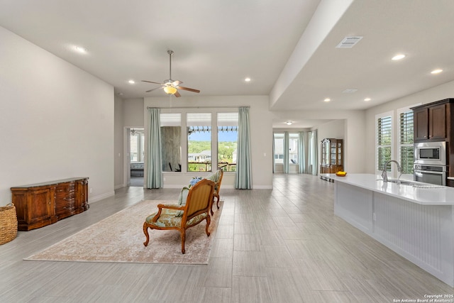 28114 Versant, Boerne, TX 78015 - living room featuring healthy amount of natural light, recessed lighting, ceiling fan, and light wood-style flooring