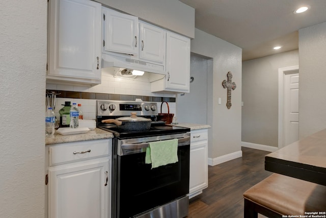 910 Halliday, San Antonio, TX 78210 - kitchen with electric range, under cabinet range hood, dark wood-type flooring, tasteful backsplash, and white cabinets