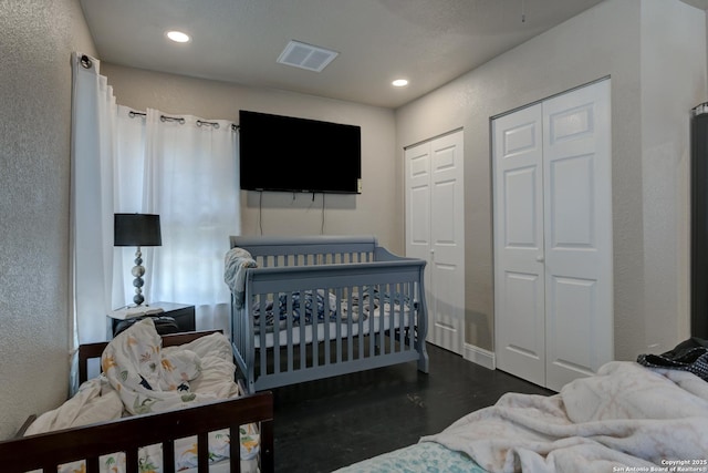 910 Halliday, San Antonio, TX 78210 - bedroom with two closets, recessed lighting, baseboards, and concrete floors