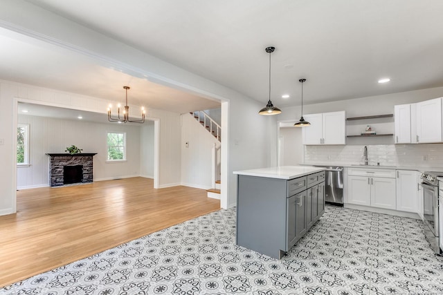 123 W Mandalay, San Antonio, TX 78212 - kitchen featuring open shelves, gray cabinets, light countertops, appliances with stainless steel finishes, and white cabinets