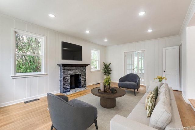 123 W Mandalay, San Antonio, TX 78212 - living room featuring a decorative wall, light wood-style floors, a fireplace, crown molding, and recessed lighting