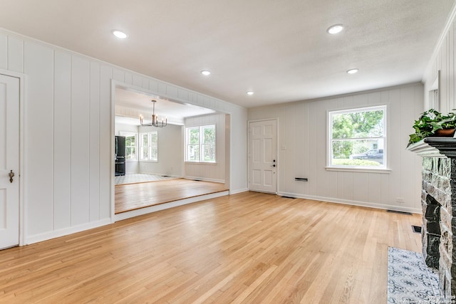 123 W Mandalay, San Antonio, TX 78212 - unfurnished living room with a decorative wall, light wood finished floors, baseboards, a fireplace, and recessed lighting