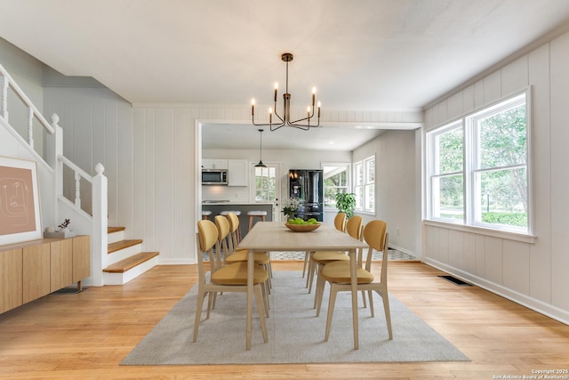 123 W Mandalay, San Antonio, TX 78212 - dining room featuring light wood-style flooring, a chandelier, stairway, ornamental molding, and baseboards