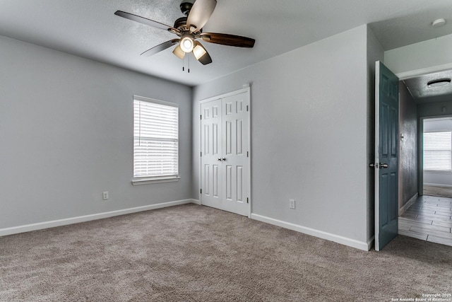 4439 Tropical Dr, San Antonio, TX 78218 - unfurnished bedroom featuring carpet, baseboards, a closet, and a ceiling fan