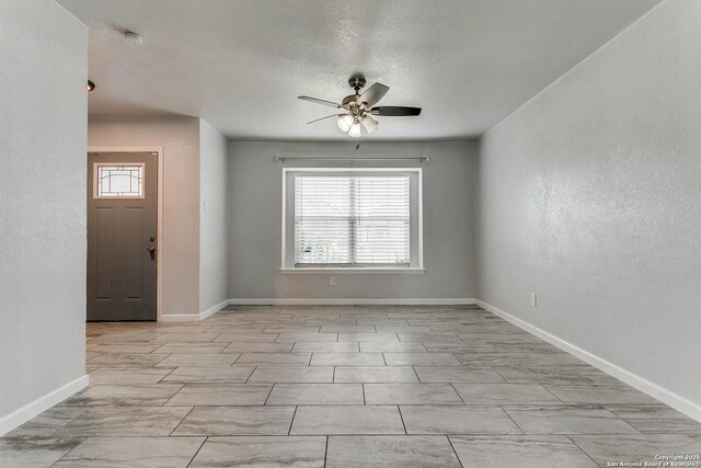 4439 Tropical Dr, San Antonio, TX 78218 - spare room with healthy amount of natural light, a ceiling fan, baseboards, and a textured ceiling