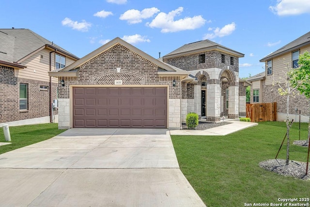 french provincial home with brick siding, a garage, driveway, and stone siding