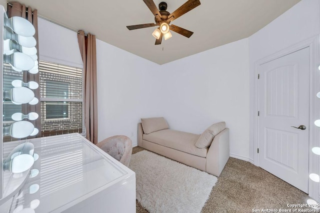 living room with ceiling fan, carpet floors, baseboards, and washer / clothes dryer