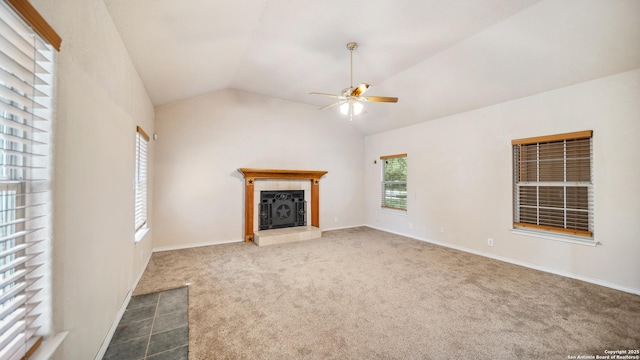 217 Sky View Dr, Adkins, TX 78101 - unfurnished living room featuring a ceiling fan, a tile fireplace, vaulted ceiling, carpet flooring, and baseboards