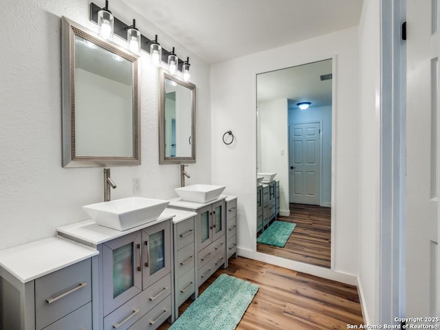 3605 Hidden Unit E1, San Antonio, TX 78217 - bathroom with wood finished floors, double vanity, and baseboards