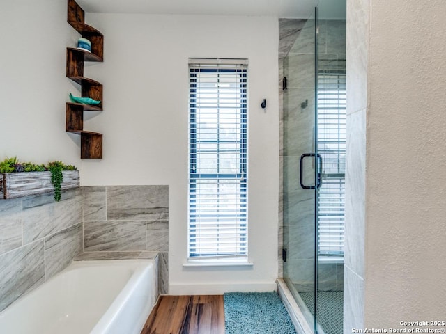 3605 Hidden Unit E1, San Antonio, TX 78217 - full bathroom featuring a stall shower, a garden tub, and wood finished floors