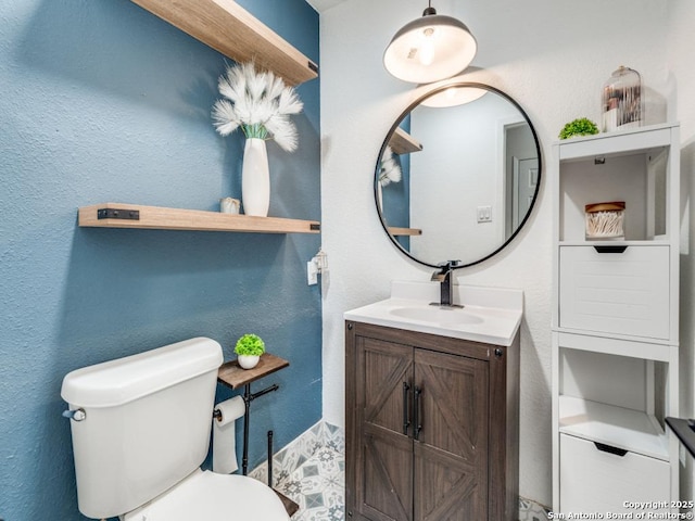 3605 Hidden Unit E1, San Antonio, TX 78217 - bathroom featuring vanity, toilet, and a textured wall