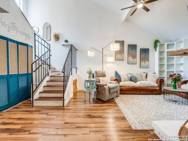 3605 Hidden Unit E1, San Antonio, TX 78217 - living room featuring high vaulted ceiling, wood finished floors, ceiling fan, stairs, and beam ceiling