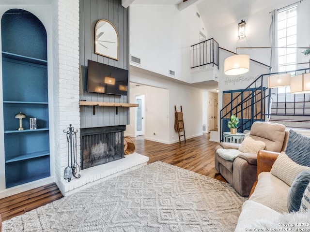 3605 Hidden Unit E1, San Antonio, TX 78217 - living room featuring stairway, wood finished floors, high vaulted ceiling, baseboards, and built in features