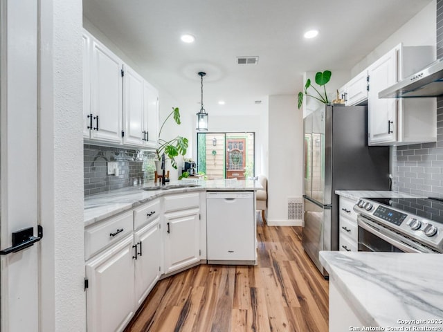 3605 Hidden Unit E1, San Antonio, TX 78217 - kitchen featuring appliances with stainless steel finishes, white cabinets, a peninsula, and recessed lighting