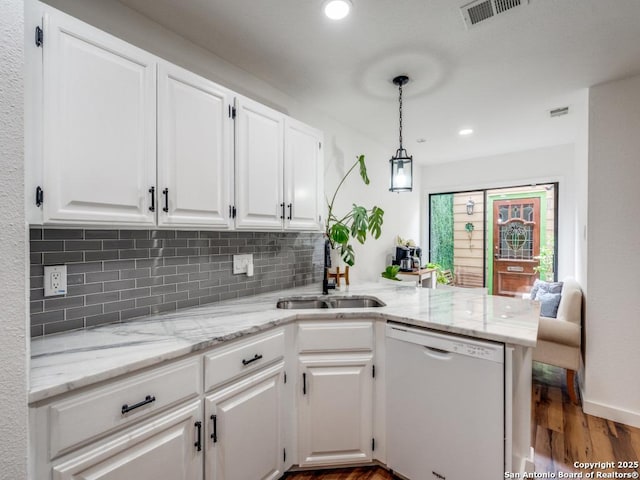3605 Hidden Unit E1, San Antonio, TX 78217 - kitchen featuring white dishwasher, a sink, a peninsula, white cabinetry, and dark wood finished floors