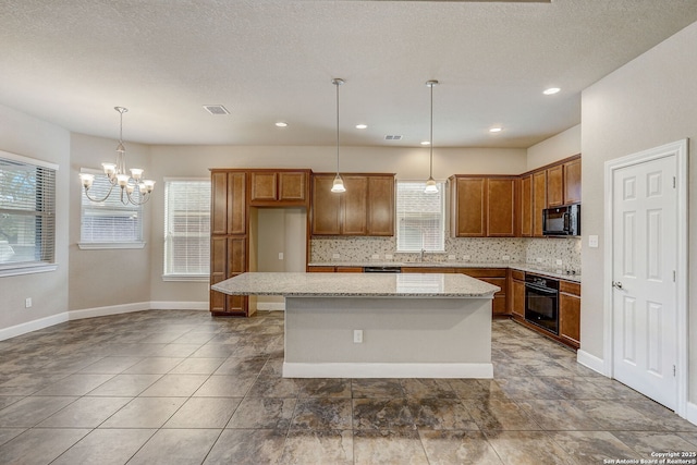 3419 Cherokee, San Antonio, TX 78253 - kitchen featuring black appliances, a chandelier, backsplash, a kitchen island, and brown cabinetry