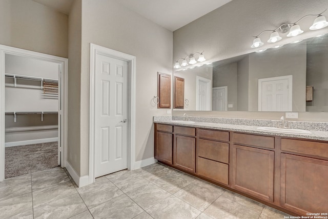 3419 Cherokee, San Antonio, TX 78253 - bathroom with double vanity, baseboards, and a walk in closet