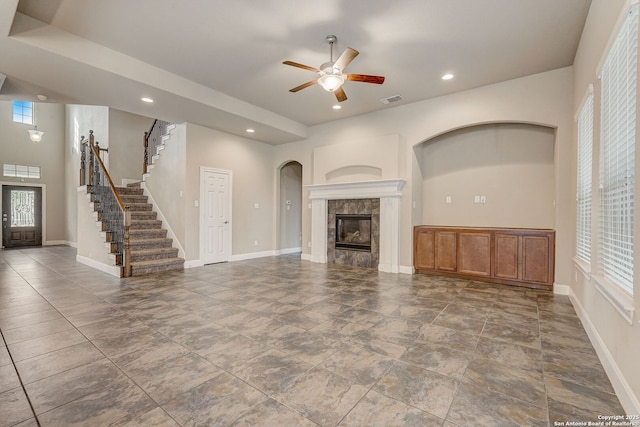 3419 Cherokee, San Antonio, TX 78253 - unfurnished living room with a ceiling fan, stairs, a tile fireplace, recessed lighting, and arched walkways